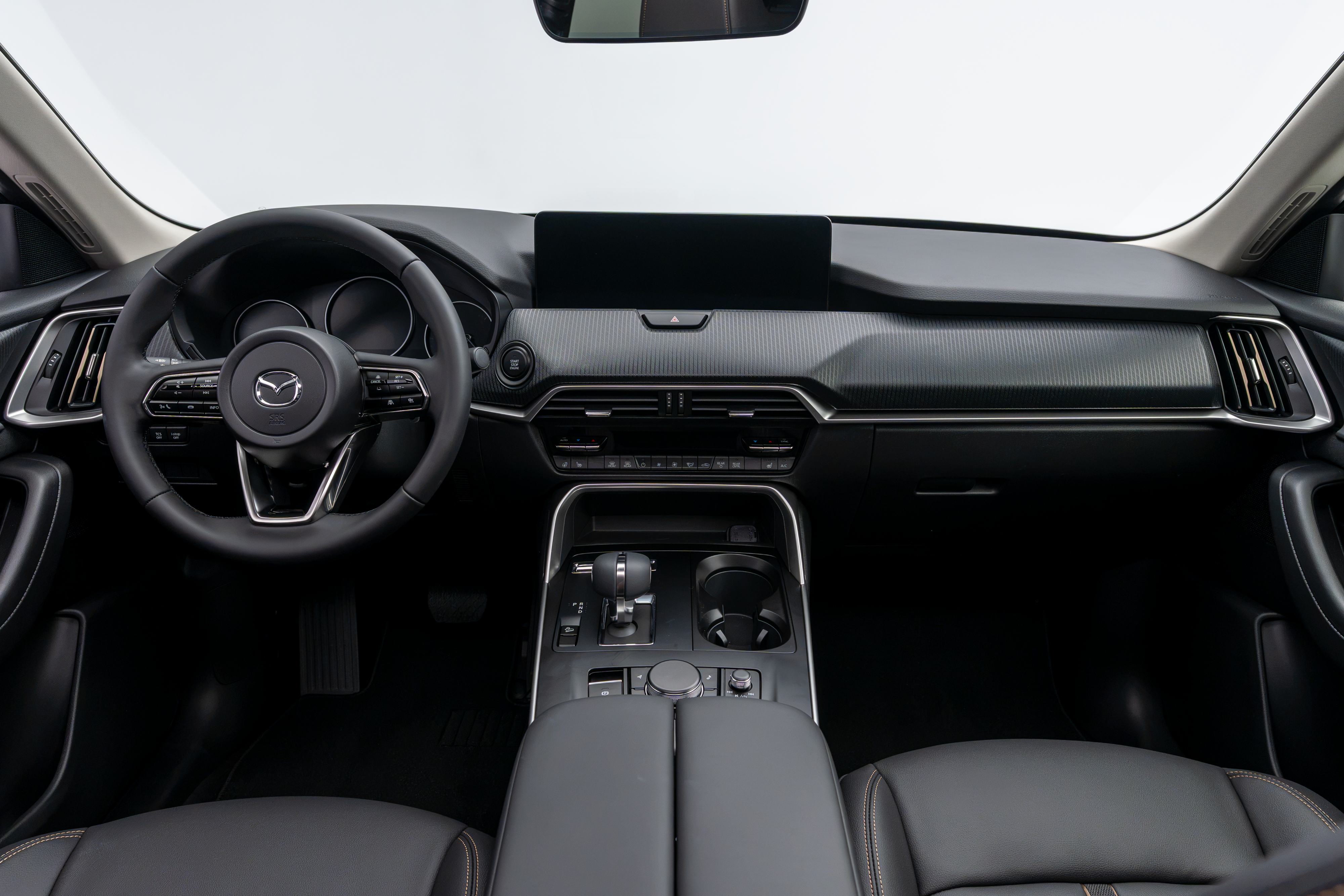 2026 Mazda CX-90 interior dashboard with steering wheel, infotainment display, centre console and front seats.