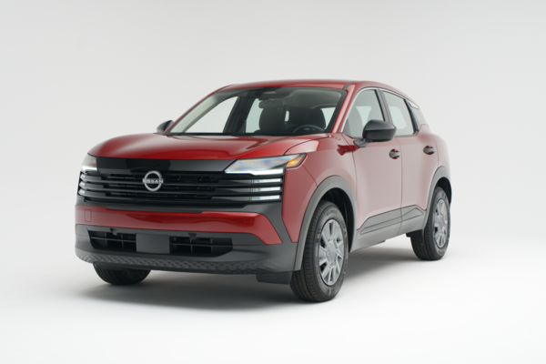 2026 Nissan Kicks in red, shown from a front three-quarter angle against a white studio background.