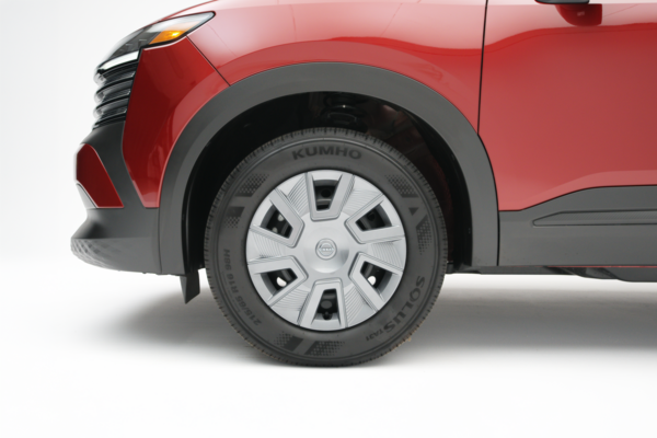 2026 Nissan Kicks front wheel featuring a silver wheel cover and black Kumho tire.