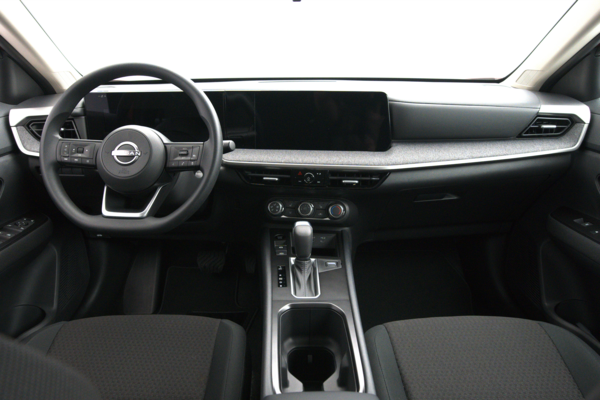 2026 Nissan Kicks interior featuring a black dashboard, steering wheel, digital display, gear shifter and centre console.