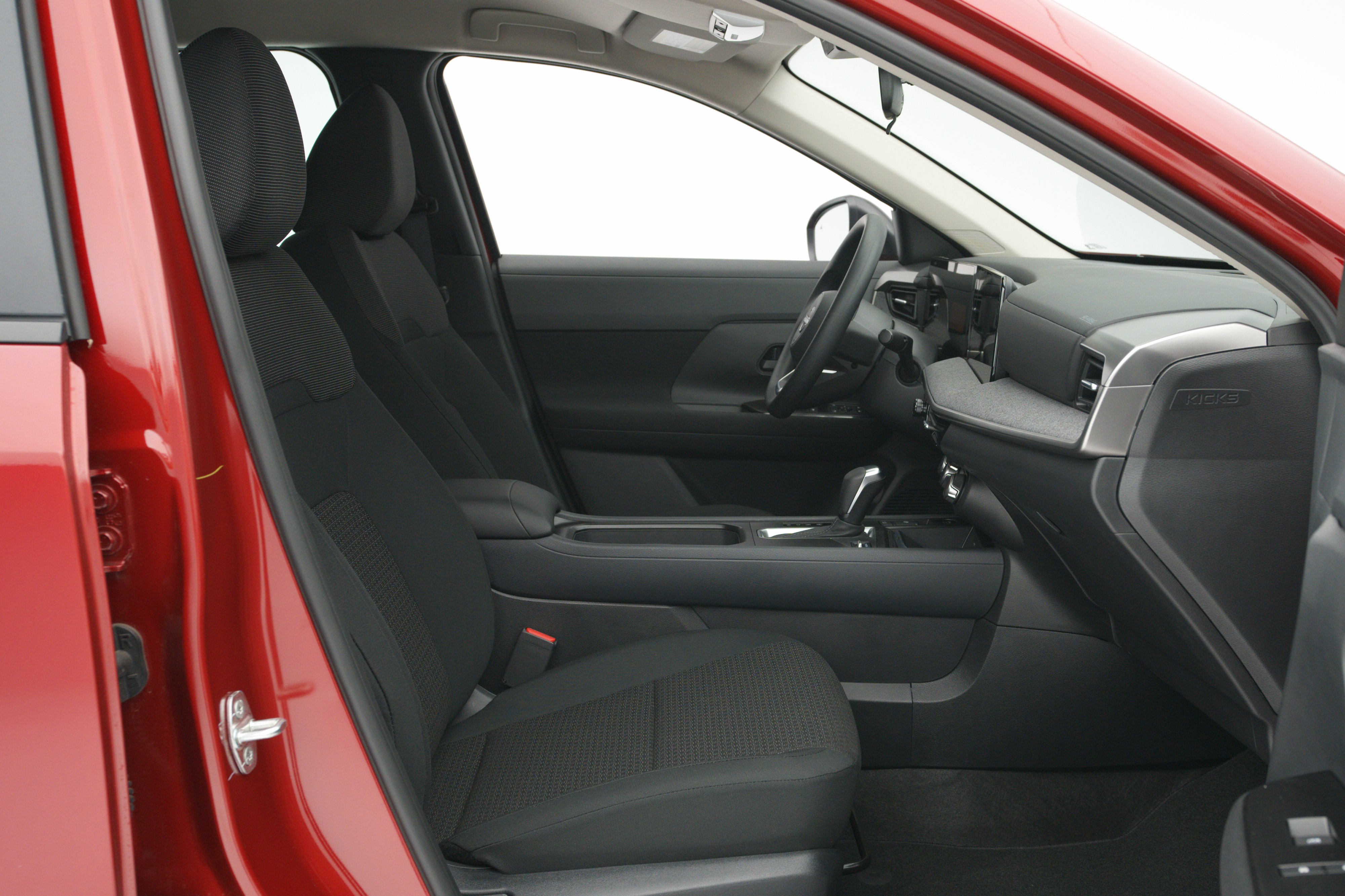 2026 Nissan Kicks front interior with black seats, dashboard, centre console and digital displays.