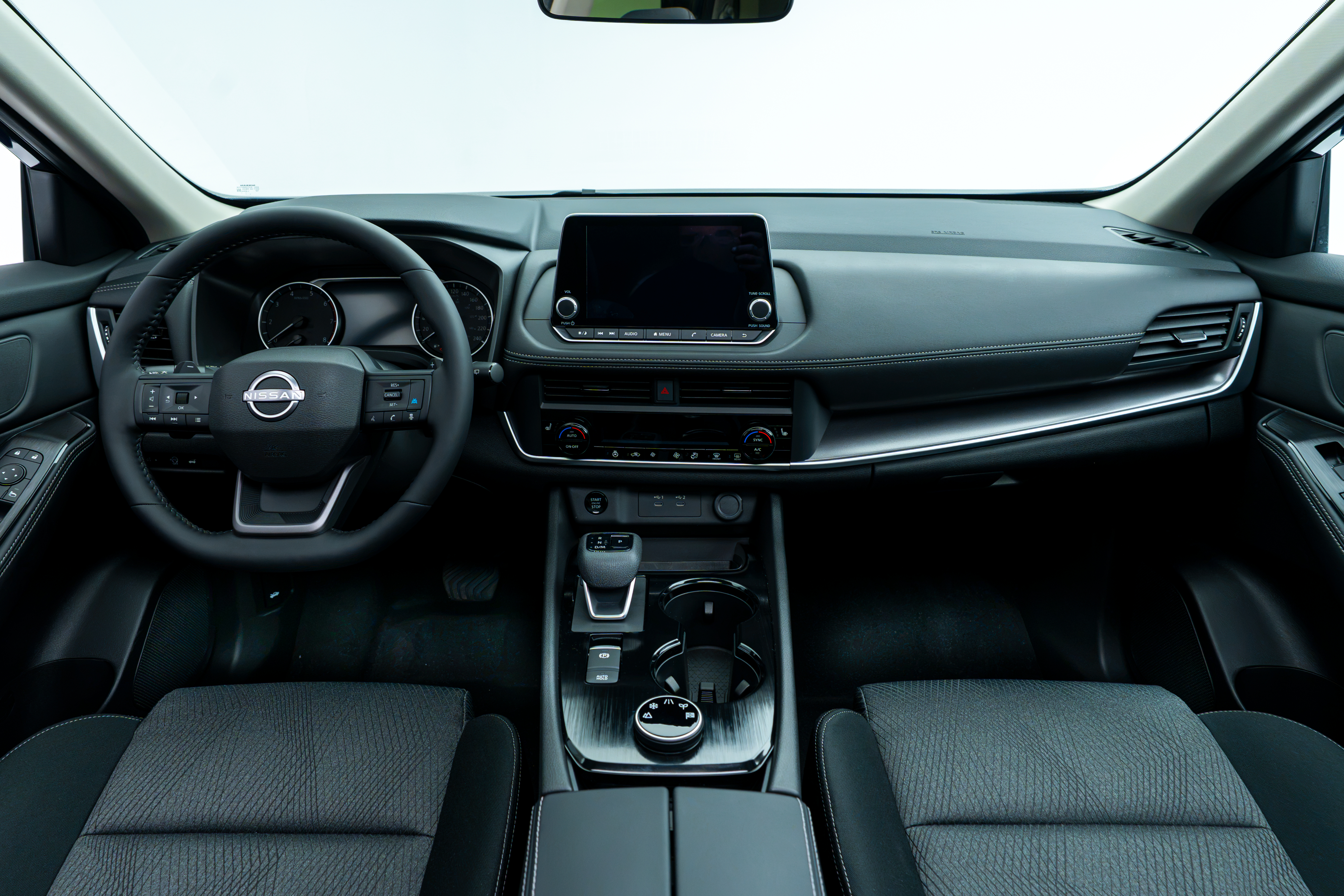 Nissan Rogue SV Moonroof interior dashboard with steering wheel, infotainment display, centre console and front seats.