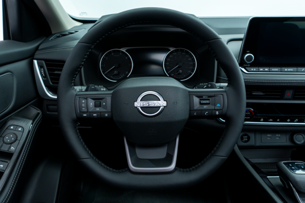 Nissan Rogue SV Moonroof steering wheel with driver controls, instrument cluster and infotainment display.