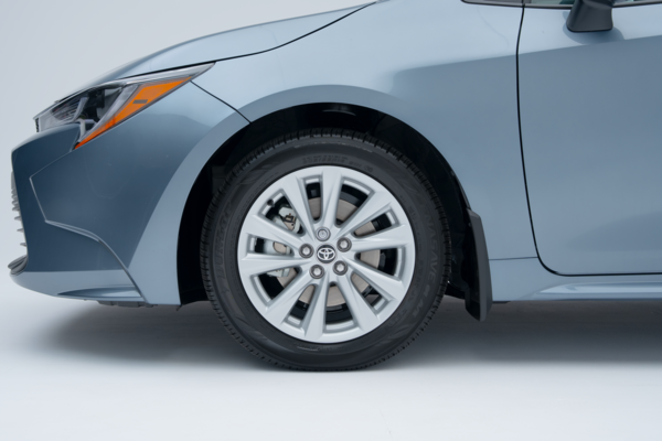 Close-up of a 2026 Toyota Corolla alloy wheel, tire and front fender.