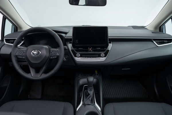 2026 Toyota Corolla interior dashboard with steering wheel, infotainment display, centre console and front seats.