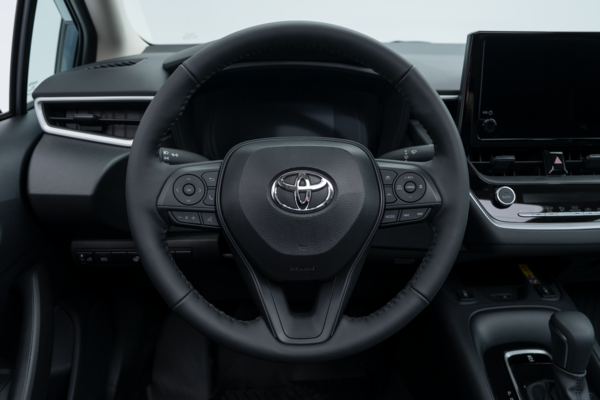 2026 Toyota Corolla steering wheel with driver controls, instrument display and dashboard.