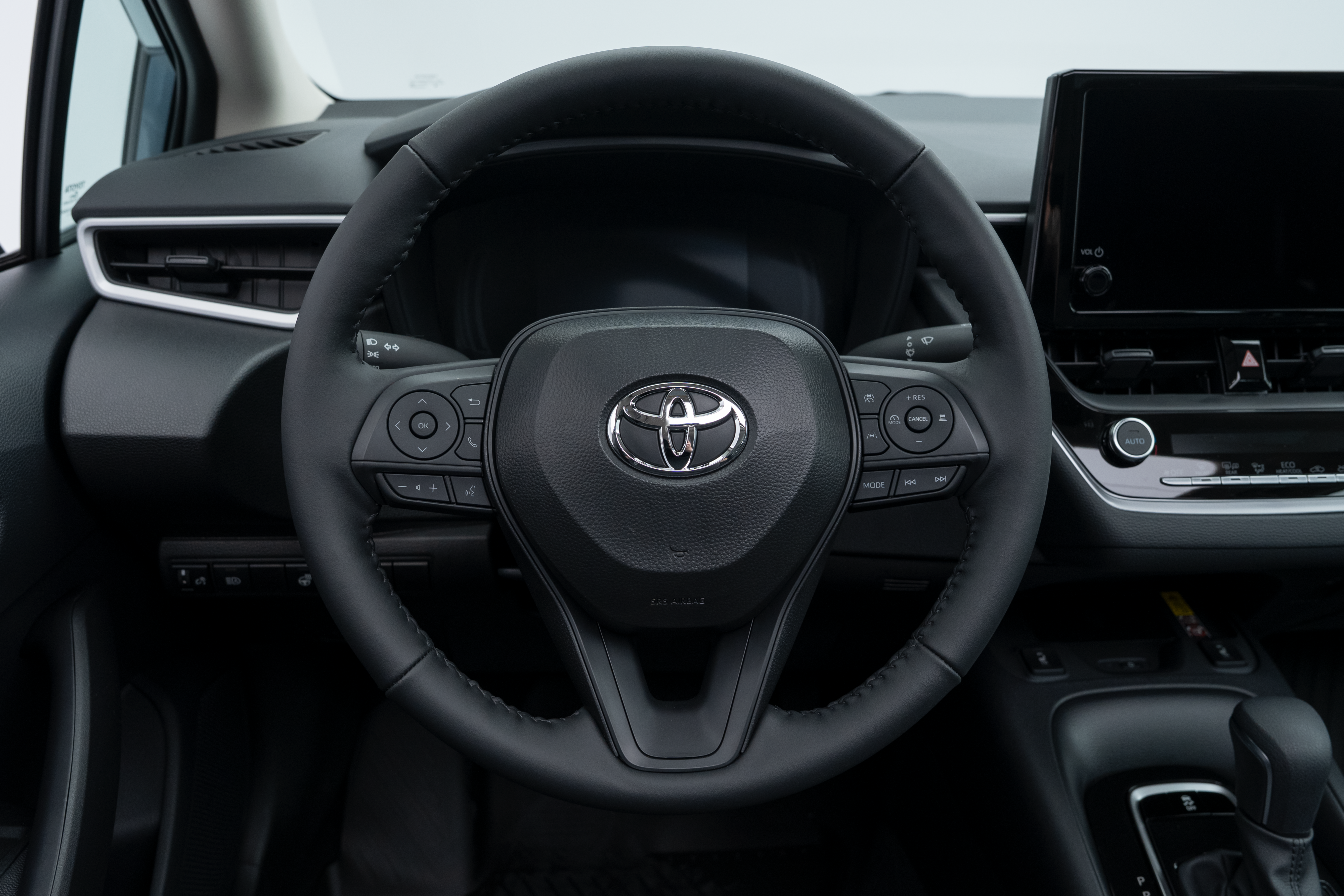 2026 Toyota Corolla steering wheel with driver controls, instrument display and dashboard.