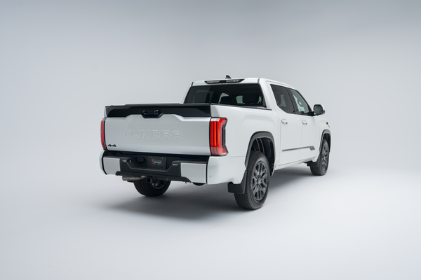 Rear three-quarter view of a 2026 Toyota Tundra showing taillights, alloy wheels, tailgate and truck bed.