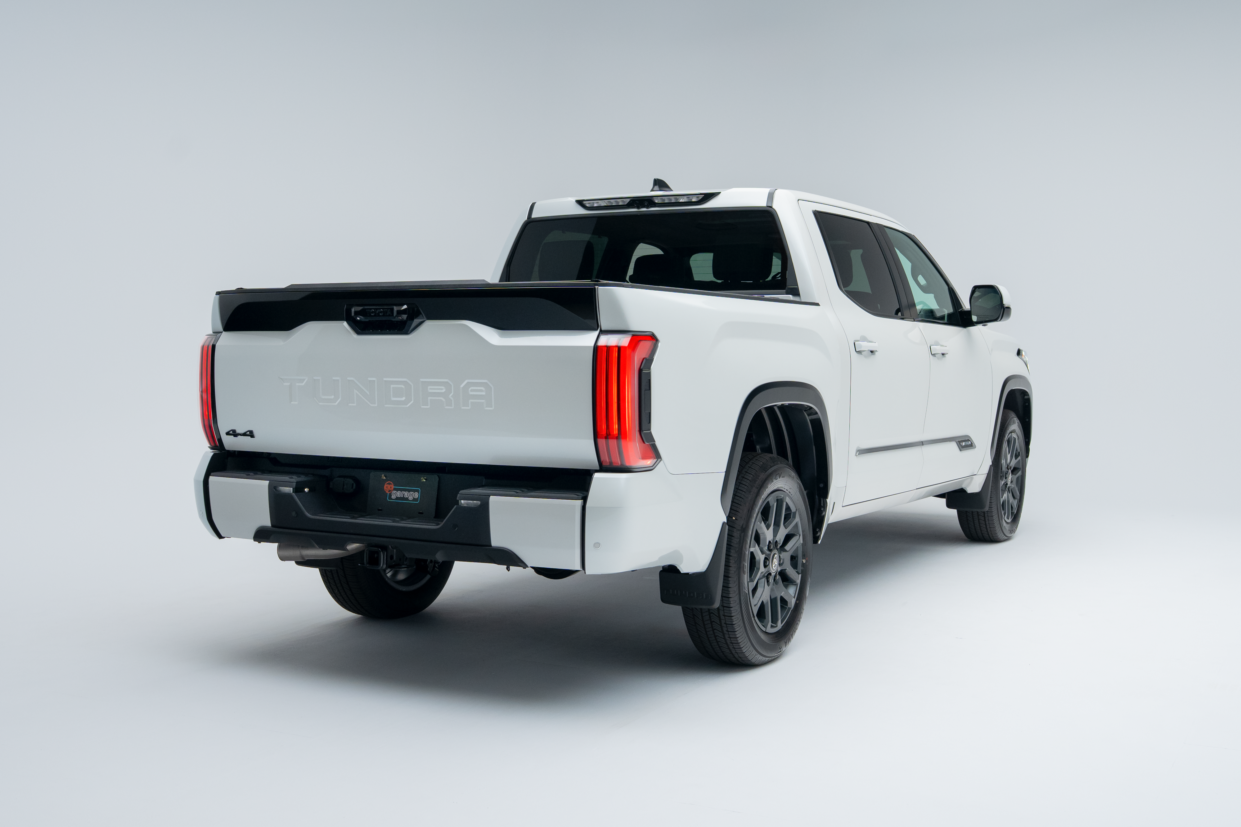 Rear three-quarter view of a 2026 Toyota Tundra showing taillights, alloy wheels, tailgate and truck bed.
