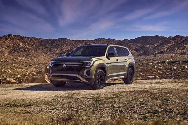 Volkswagen Atlas three-row SUV parked in desert landscape with rocky hills