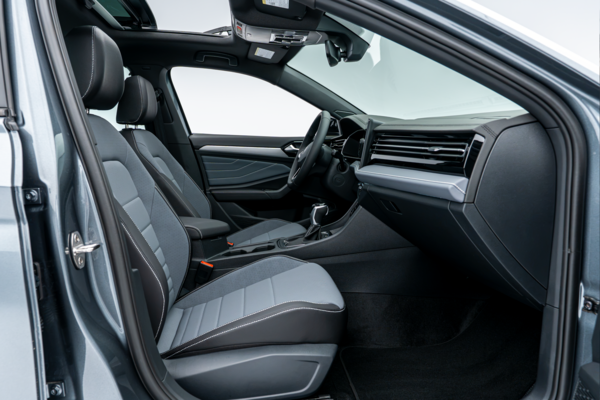 2026 Volkswagen Jetta front interior with two-tone seats, dashboard, centre console and sunroof.
