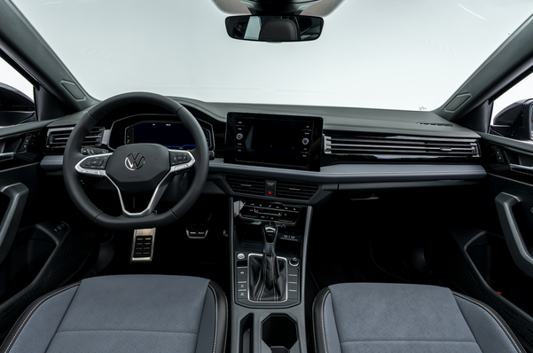 2026 Volkswagen Jetta interior, featuring the steering wheel, touchscreen display, center console and front seats.