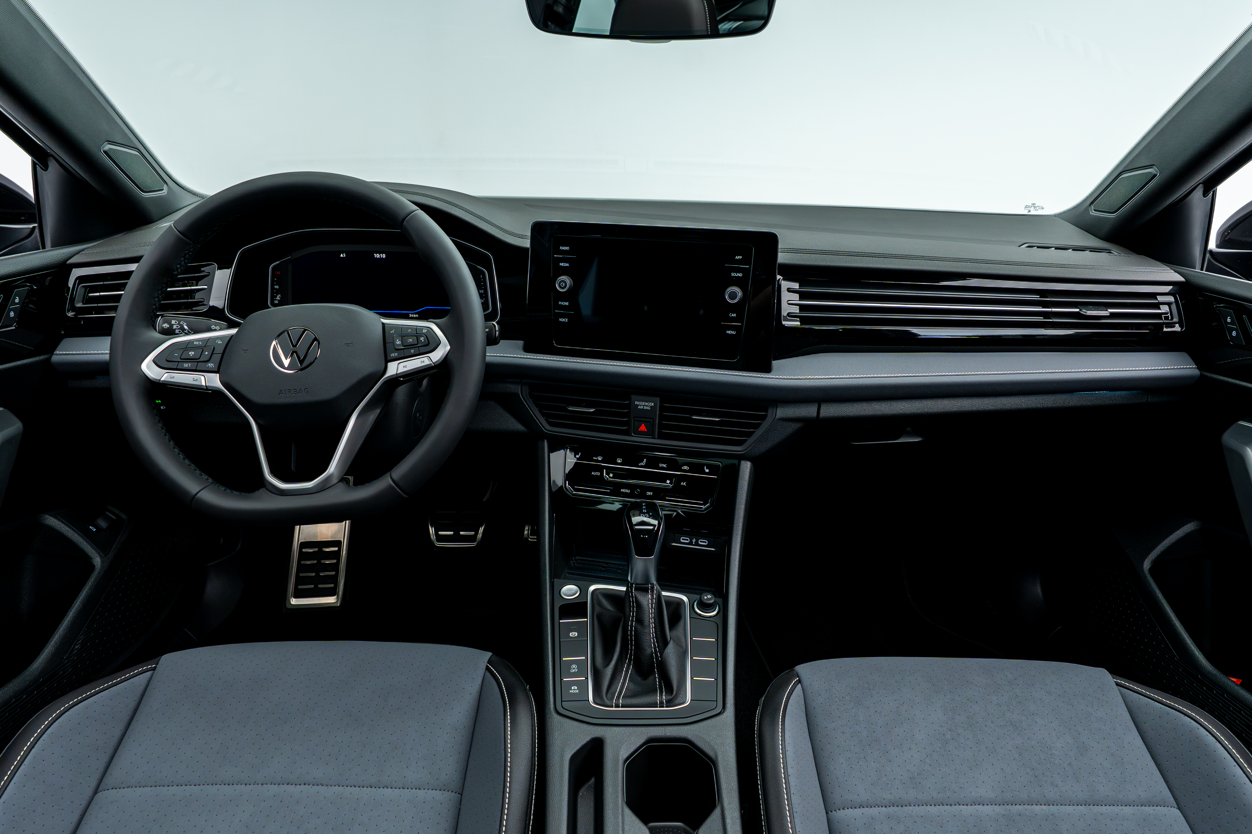 2026 Volkswagen Jetta interior, featuring the steering wheel, touchscreen display, center console and front seats.