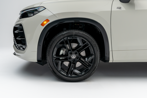 Close-up of a 2026 Volkswagen Tiguan black alloy wheel, tire and front fender.