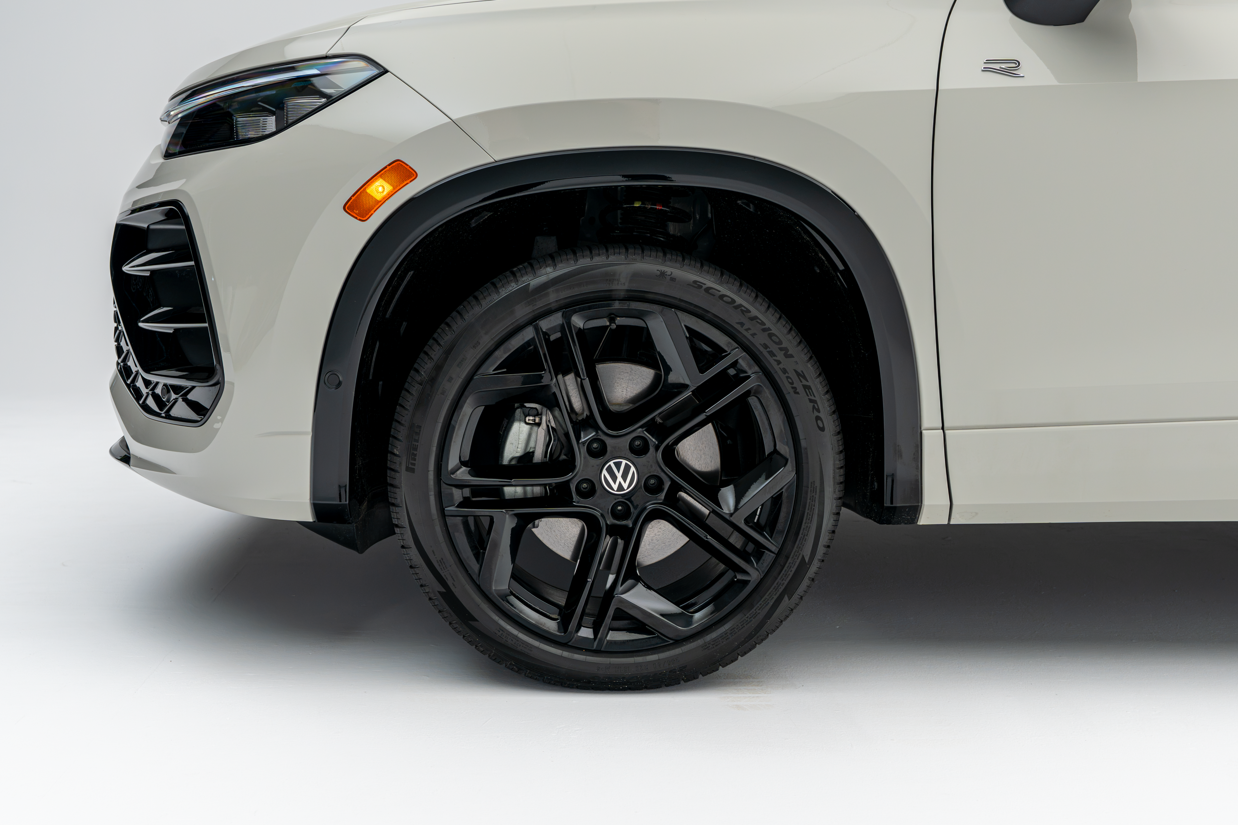 Close-up of a 2026 Volkswagen Tiguan black alloy wheel, tire and front fender.