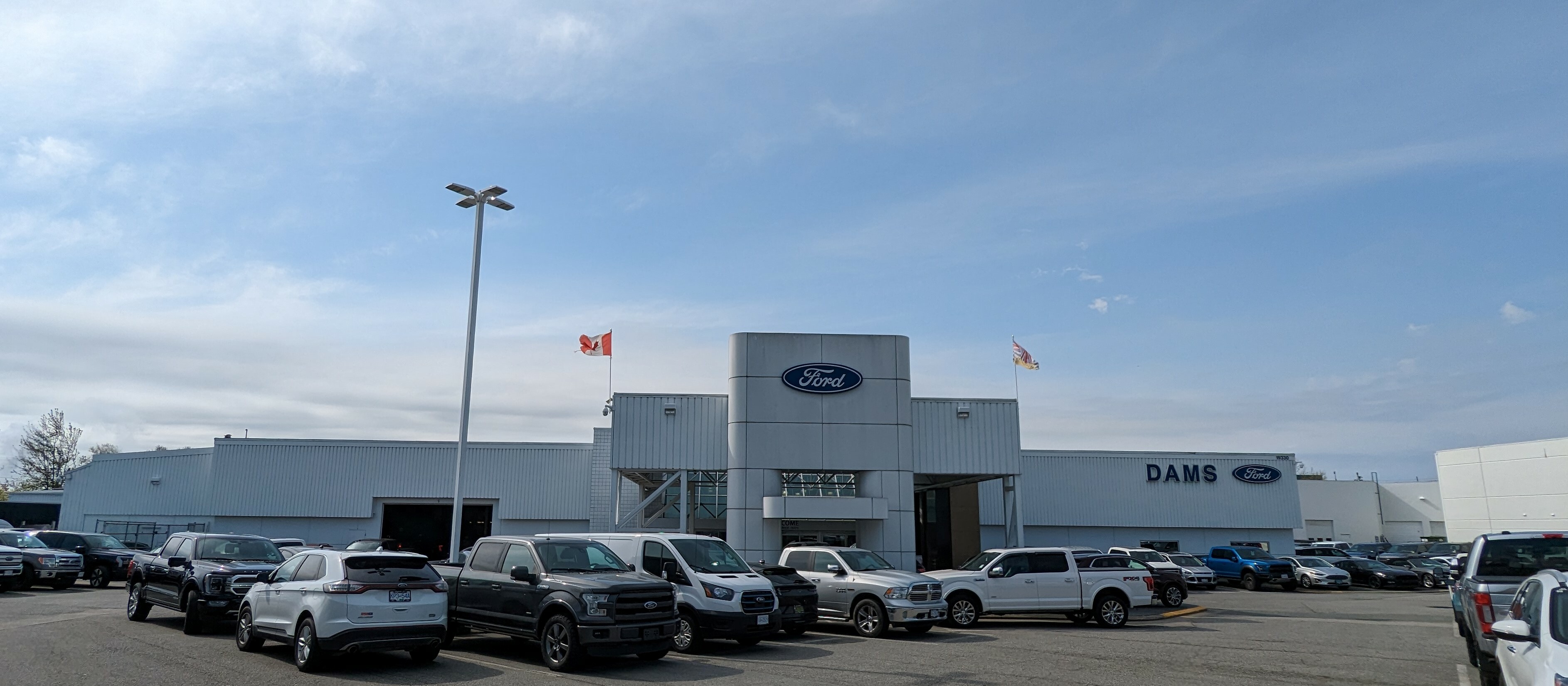 Dams Ford dealership exterior with lot of vehicles and signage