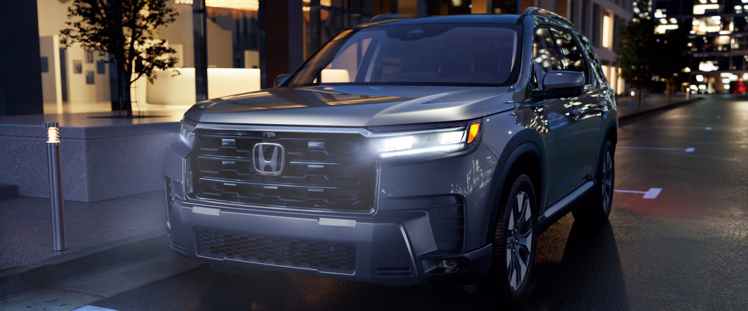 2026 Honda Pilot at night with headlights on.