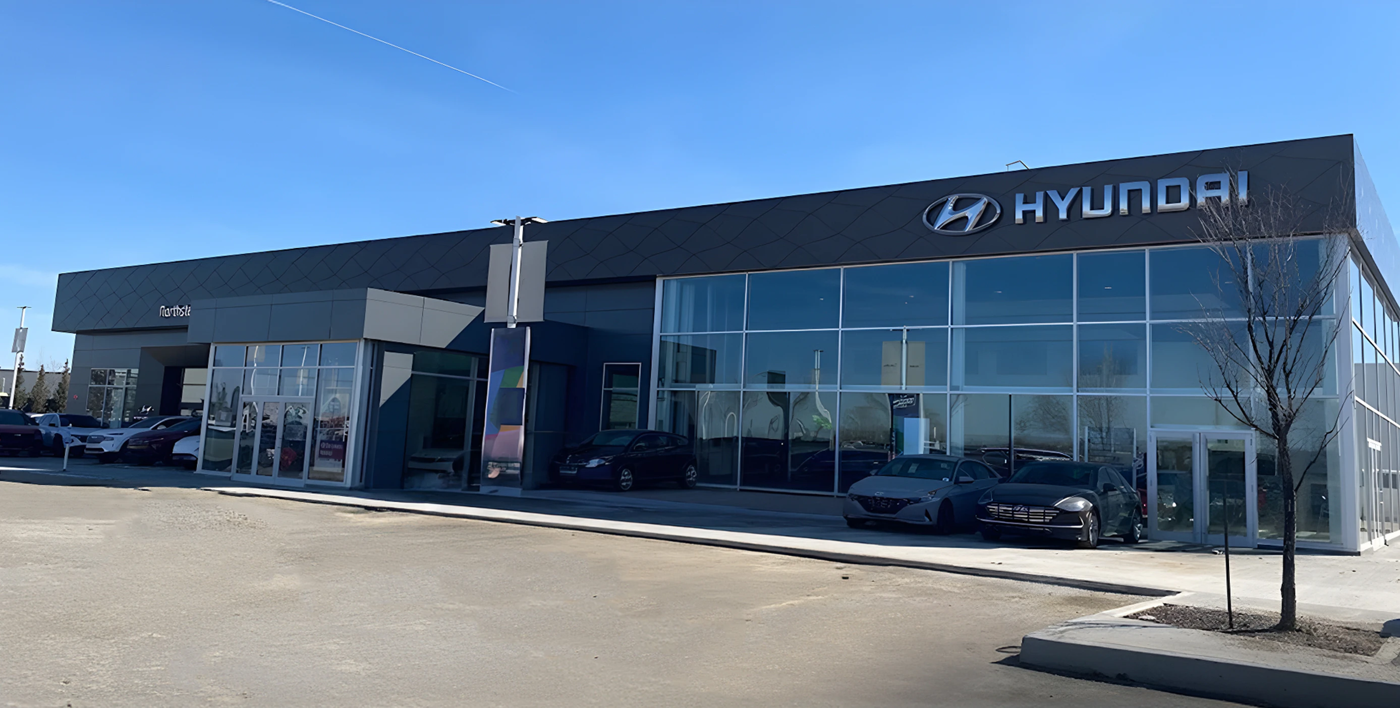 Hyundai dealership exterior with modern black storefront and large display windows