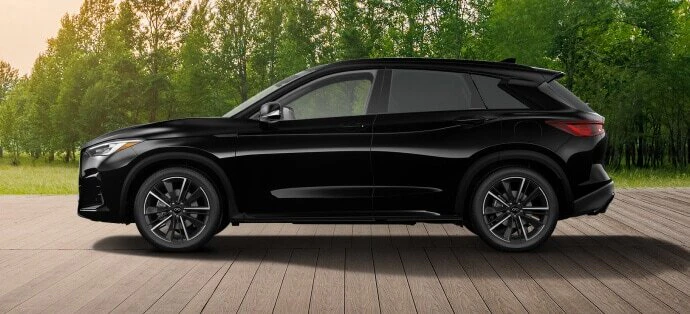2025 Infiniti QX50 black SUV parked on wooden deck with trees in background
