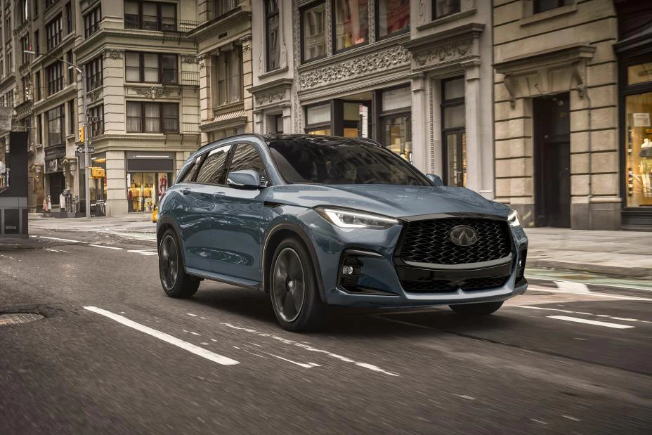 2025 Infiniti QX50 driving through urban downtown street