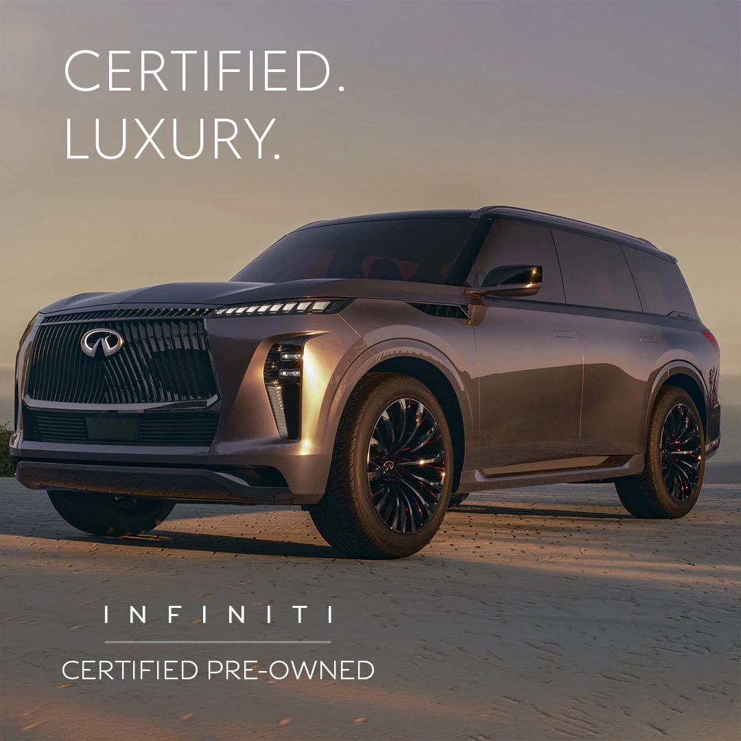 Certified pre-owned Infiniti luxury SUV parked on beach at sunset