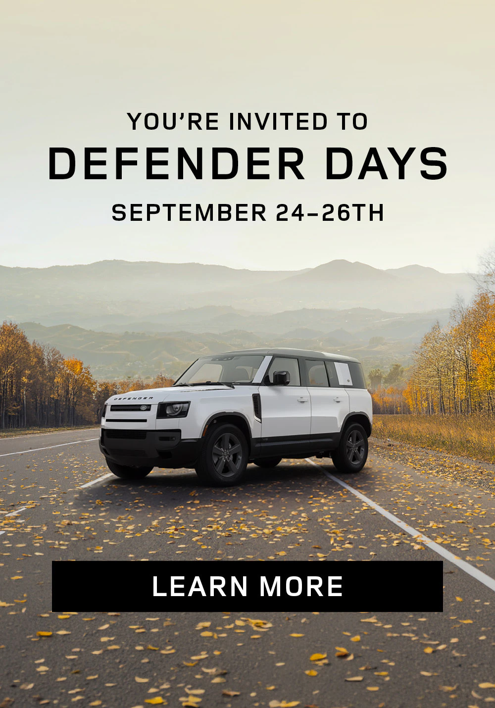 White Land Rover Defender on a scenic autumn road with mountains in the background. Text reads ‘You’re Invited to Defender Days, September 24–26th’. Mobile version.