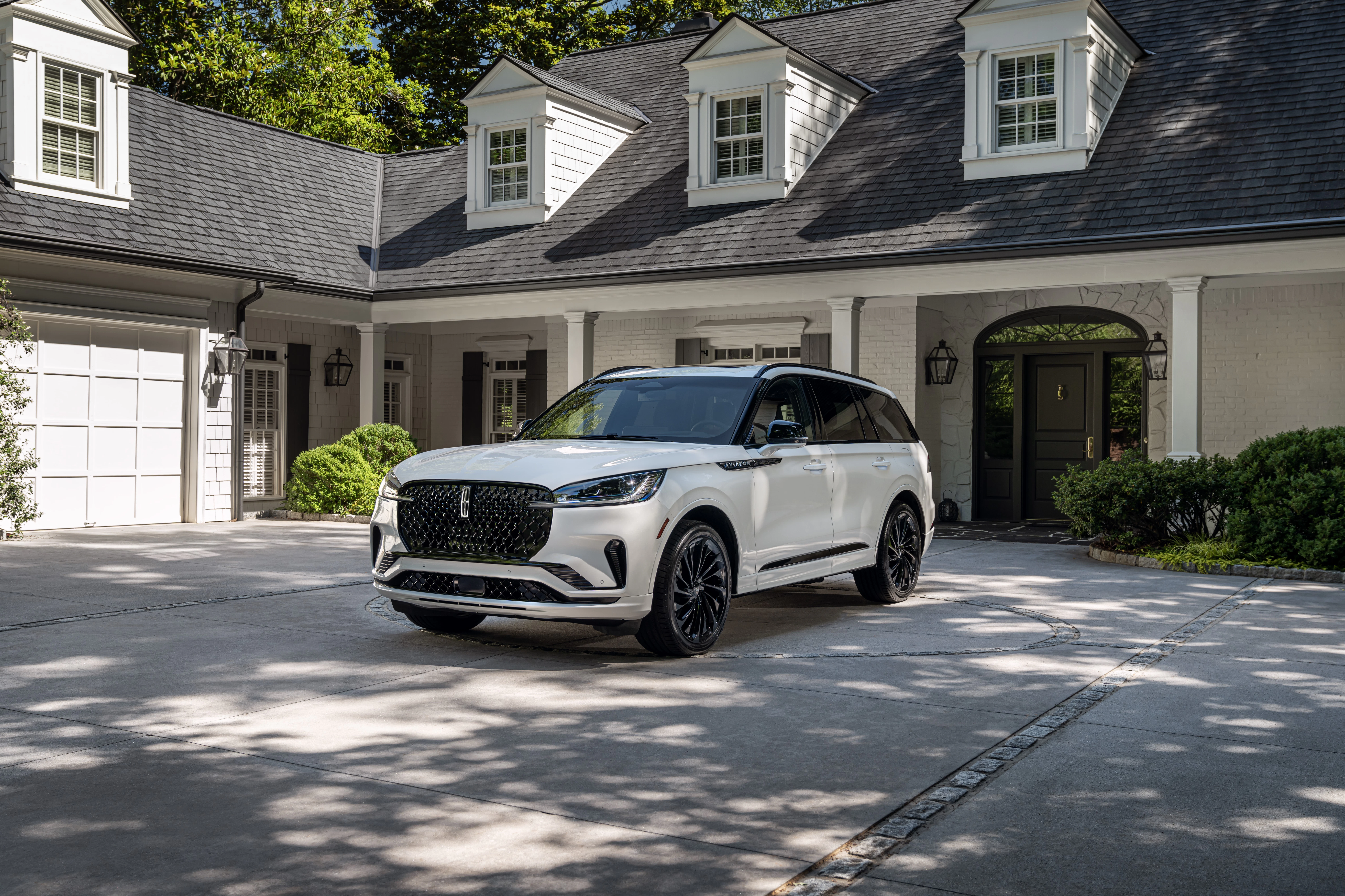 2025 Lincoln Aviator parked in front of luxury home driveway