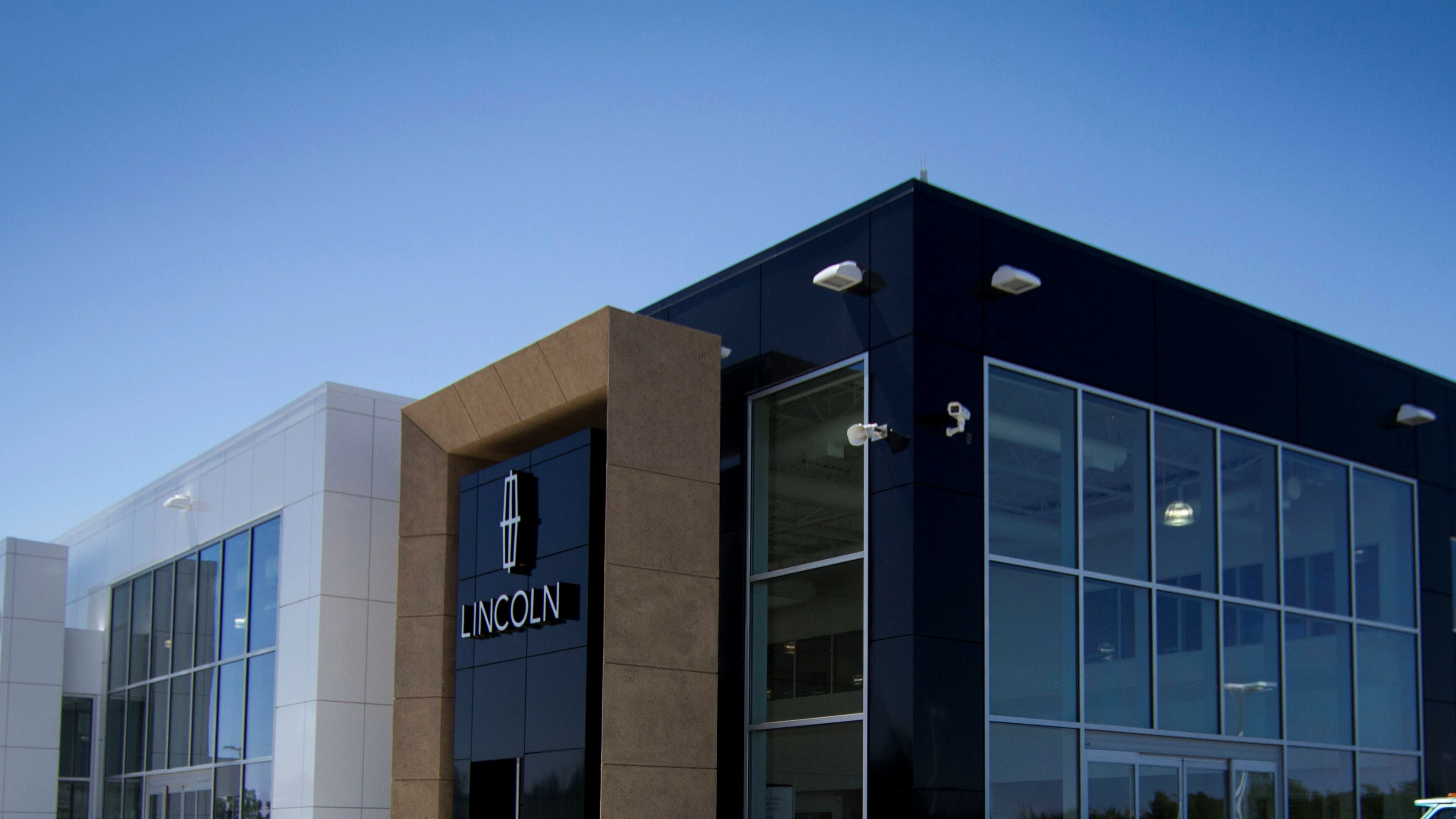 Lincoln dealership showroom exterior with modern glass and metal facade