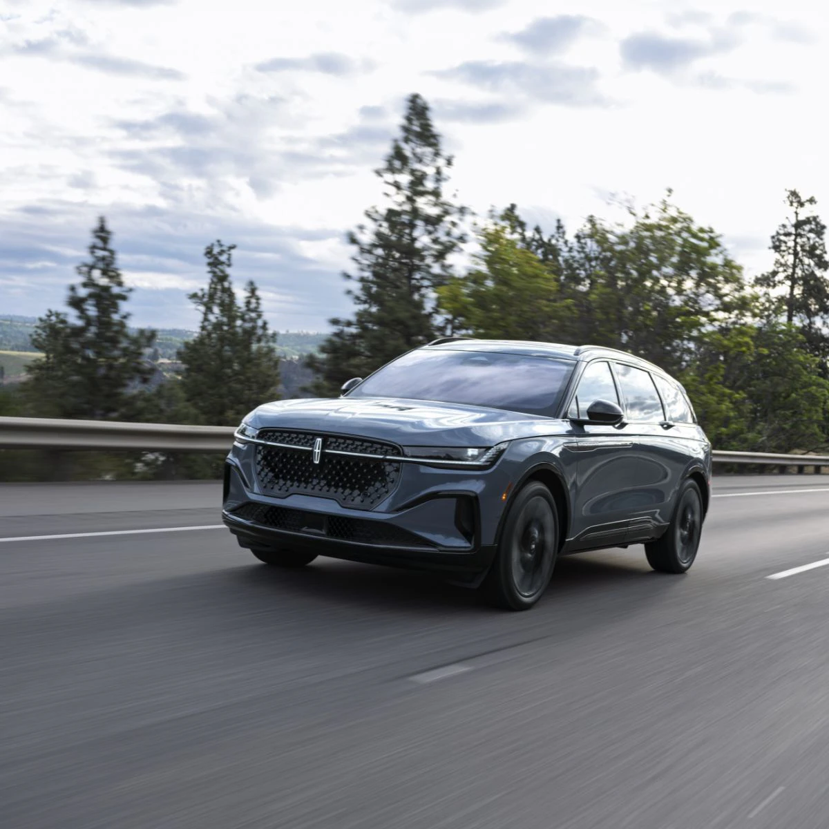 Front view of grey Lincoln Nautilus driving on the road.
