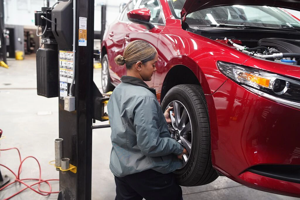 Service Tech removing tire at Go Mazda.