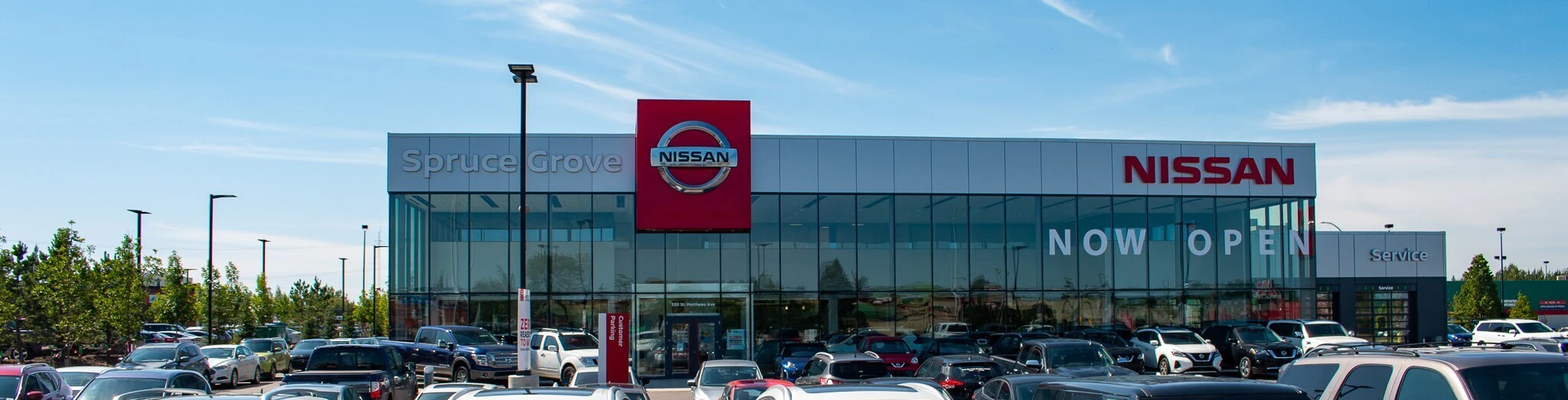 Grove Nissan dealership exterior with parking lot and inventory vehicles