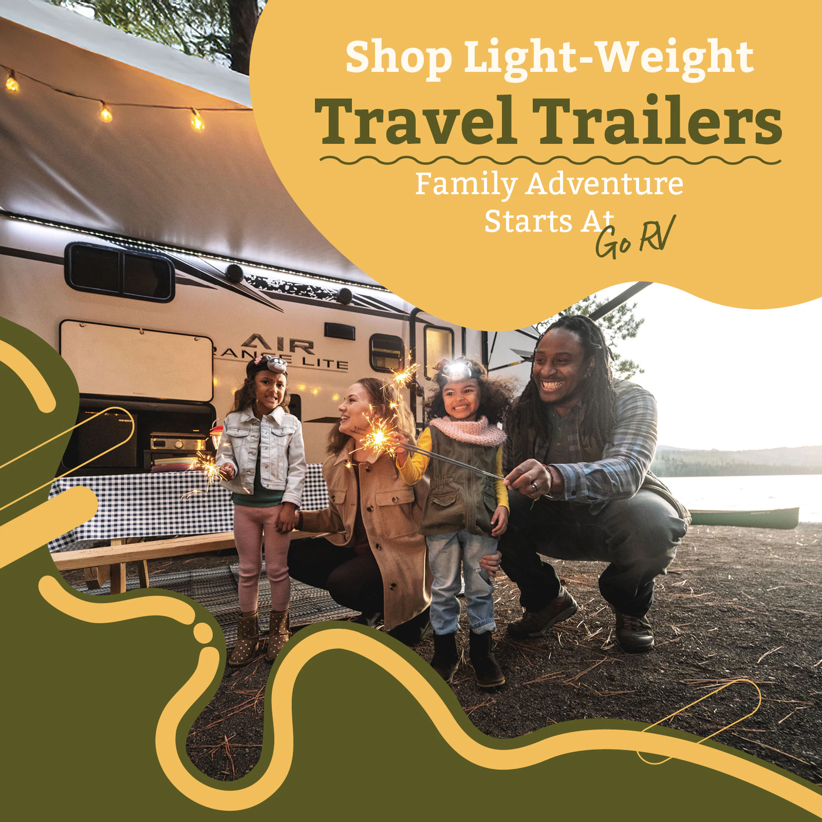Family holding sparklers in front of light-weight travel trailer by a lake