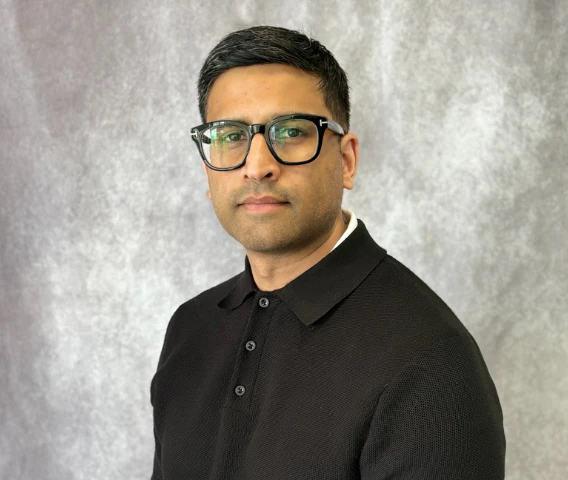 Paul Naicken, Go Auto dealership staff member, wearing glasses and black polo shirt