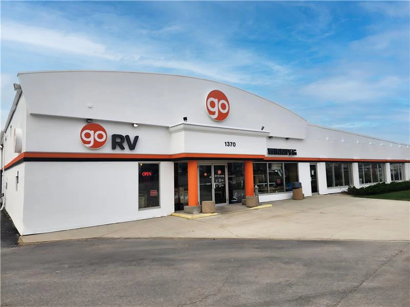 Go RV dealership building exterior with white curved roof and orange trim accents