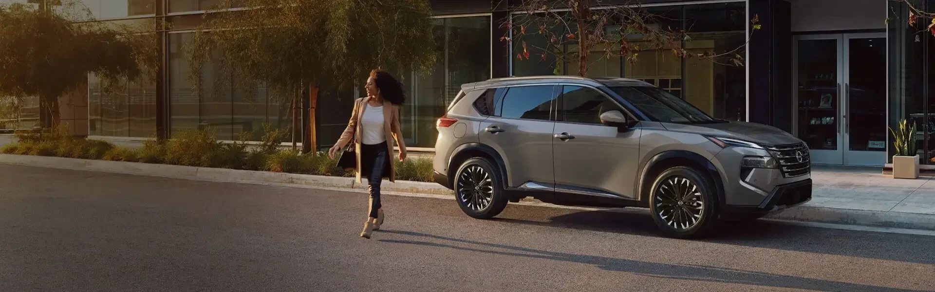 Nissan Rogue parked on street with woman jogging nearby