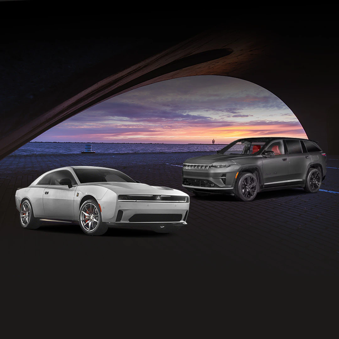 Dodge Charger Daytona and Jeep Wagoneer S displayed under bridge at sunset