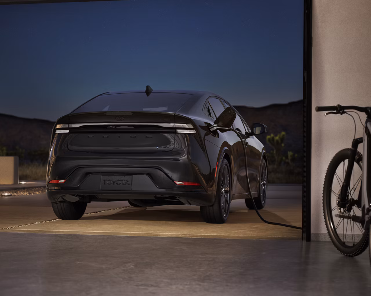 Toyota on the Trail - 2026 Prius Plug-In Hybrid Nightshade Edition exterior charging at night