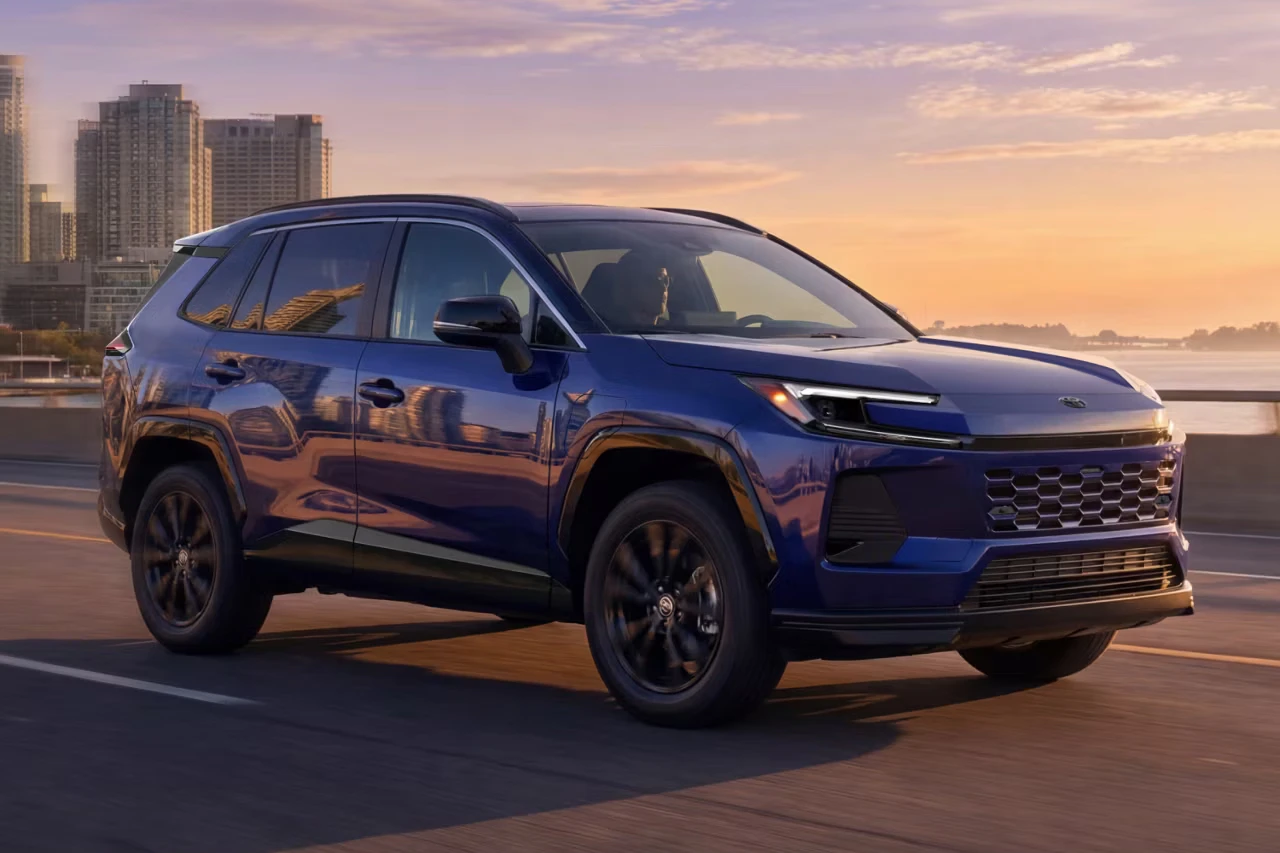Toyota 2026 RAV4 Plug-In Hybrid driving in the city at sunset