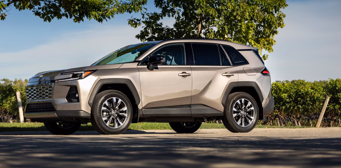 Toyota 2026 RAV4 driving in park with trees.