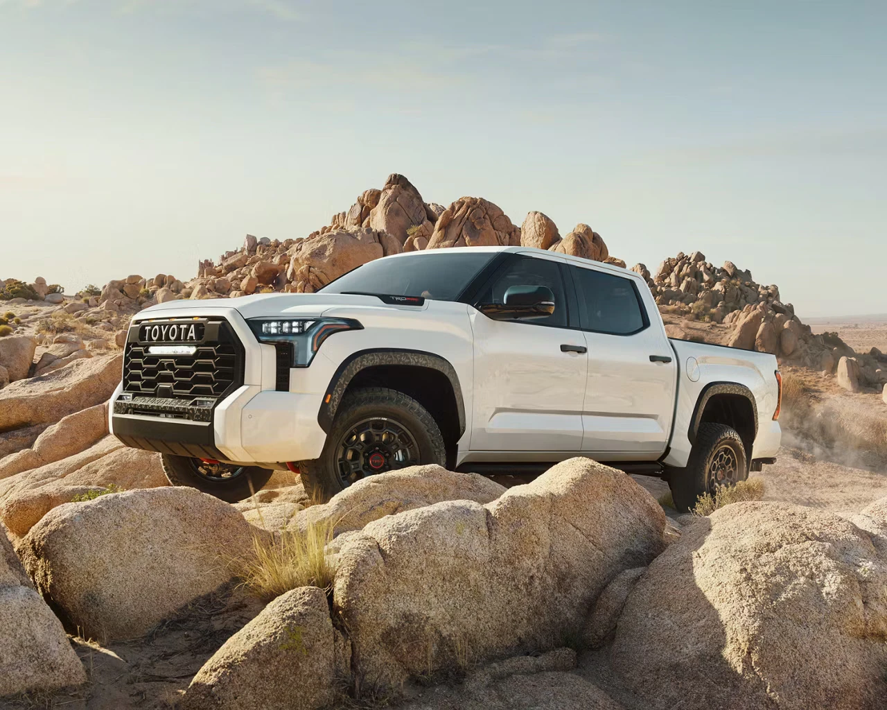 2026 Toyota Tundra Hybrid Limited TRD Pro in white navigating rocky desert terrain