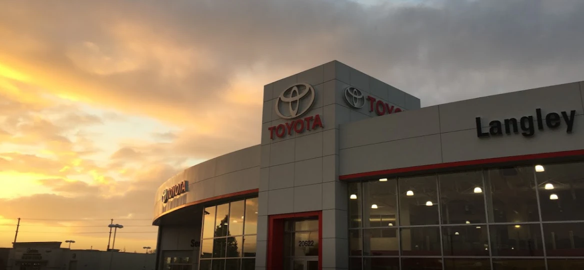 Langley Toyota dealership exterior at sunset with illuminated showroom windows