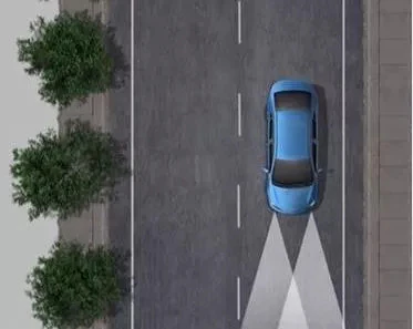 car driving down road with high beams on
