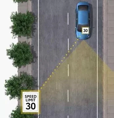blue car driving down road with a road sign