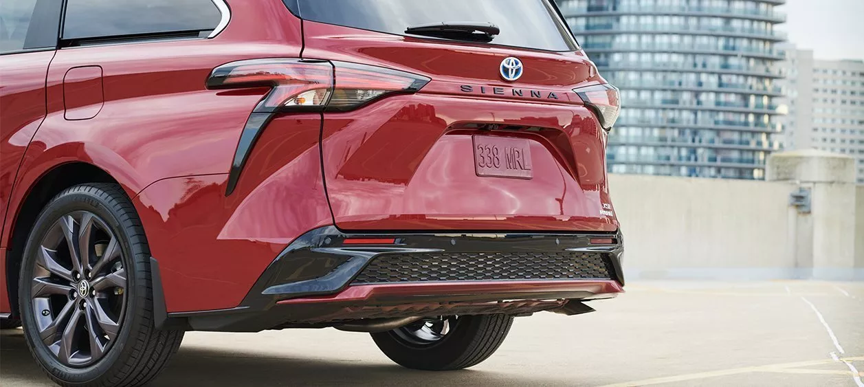 A closeup of the rear end of a red Toyota Sienna