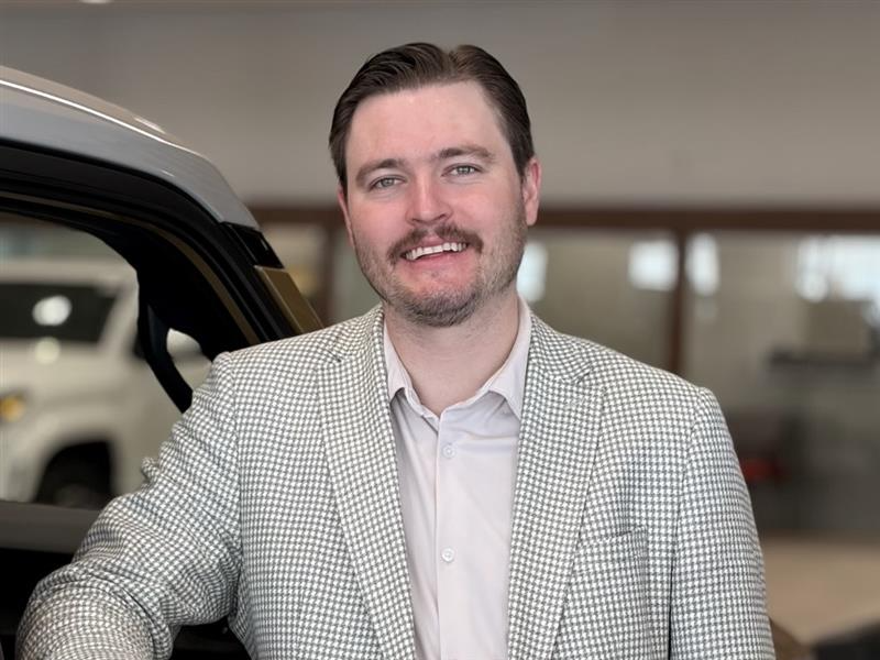 Macleod Trail Toyota staff member smiling at the dealership