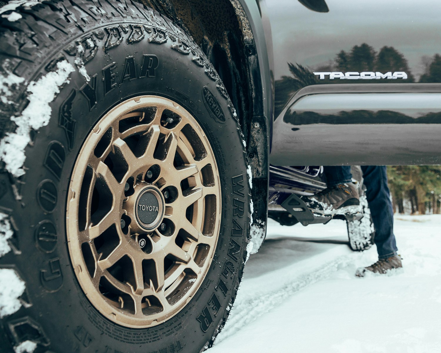 a close up of one of the wheels on a Toyota Tacoma in winter