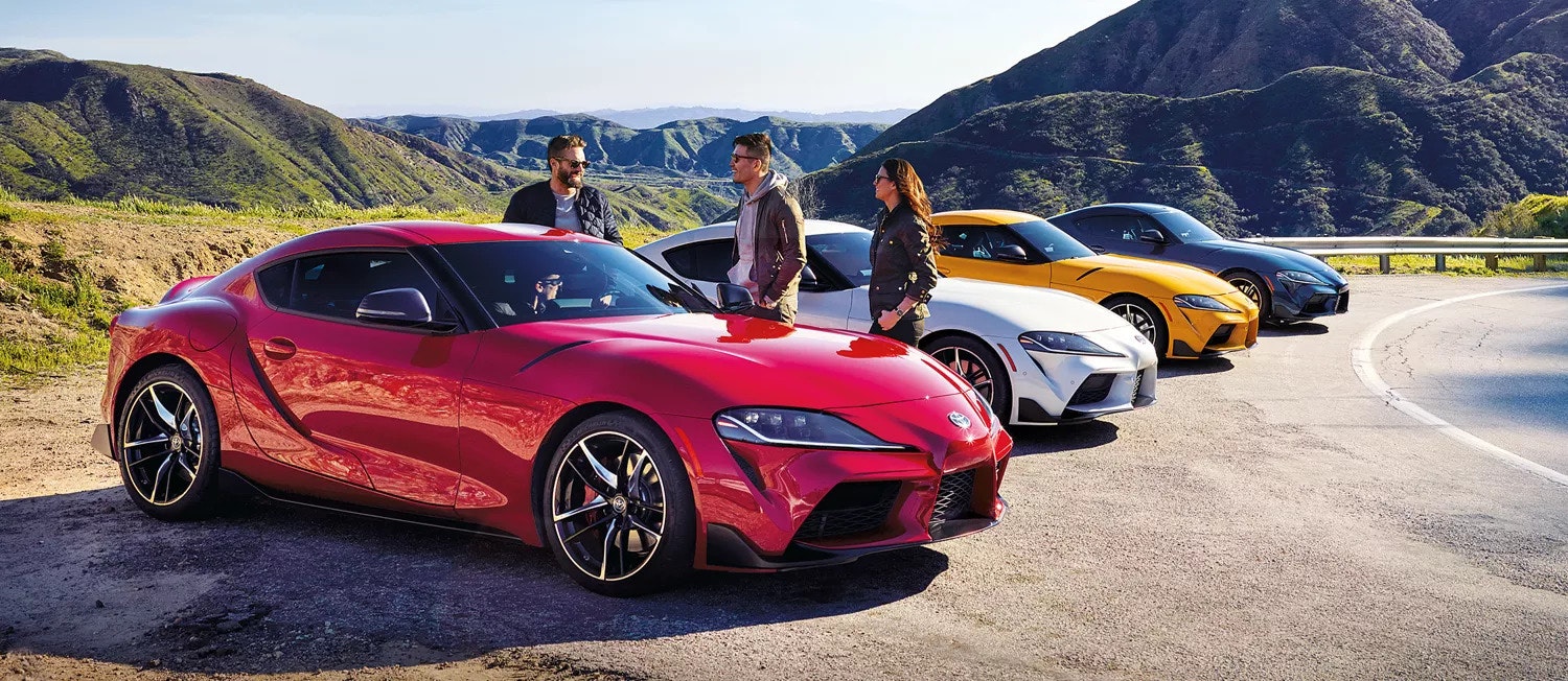 Toyota 2022 Supra Family lined up in front of a mountainous landscape