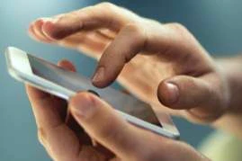person tapping on the Toyota app on their iPhone.