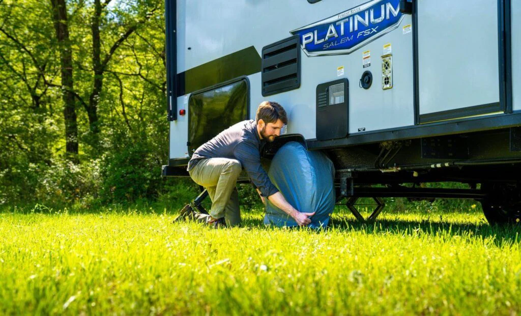 Guy is measuring the tire cover to fit his RV perfectly