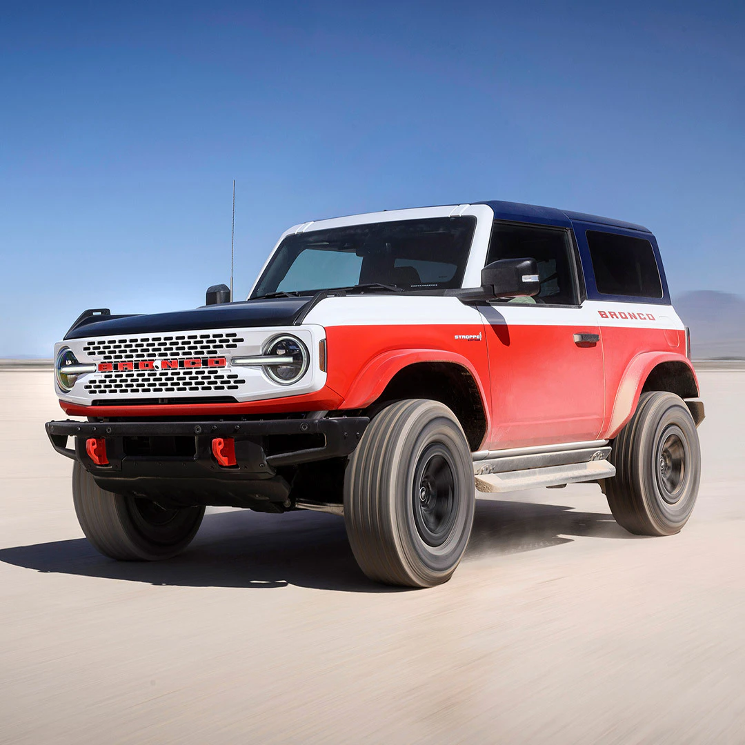 2026 Ford Bronco midsize SUV in red and white parked on sand